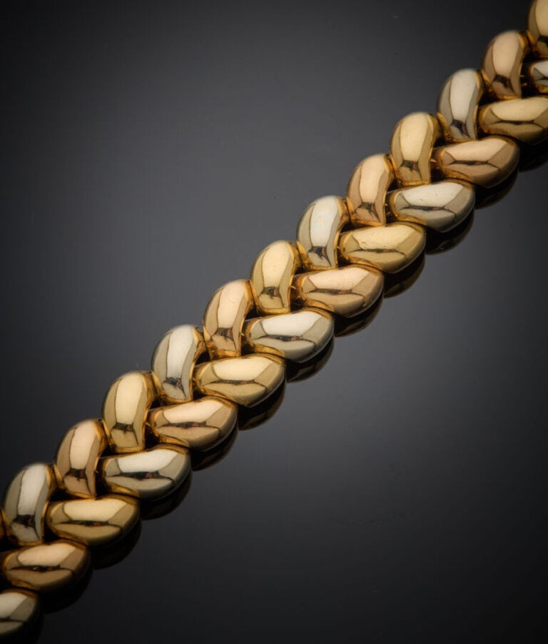 POIRAY - - BRACELET "tresse" trois ors (750‰) godronnés. - - Travail français.…