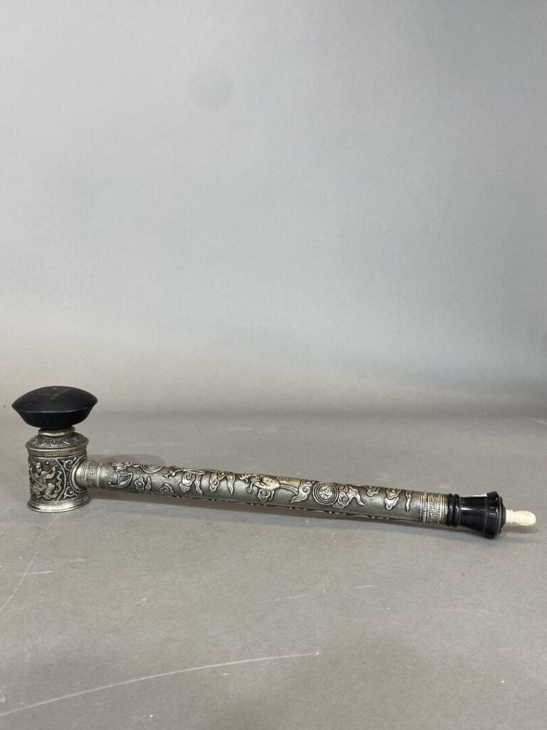 Vietnam - Pipe à opium en métal argenté à décor en léger relief des divinités F…
