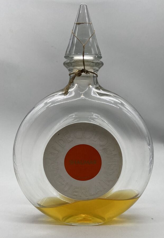 GUERLAIN , , 2 flacons : - - Un flacon lenticulaire, bouchon émeri, en forme de…