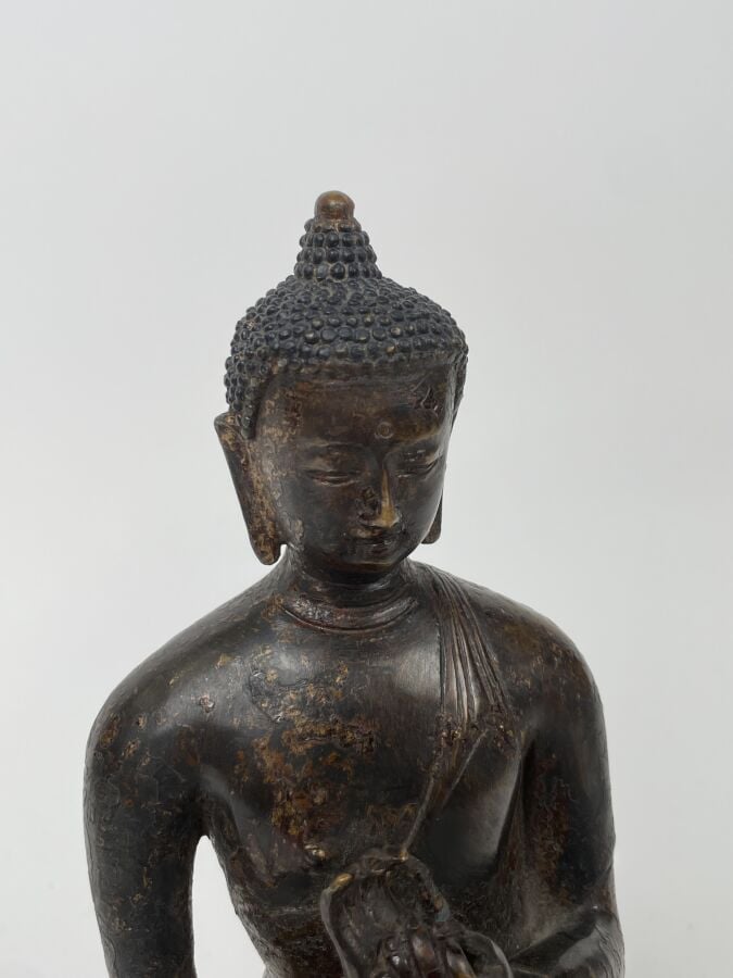 STATUE en bronze de patine brune anciennement laqué, représentant le bouddha as…