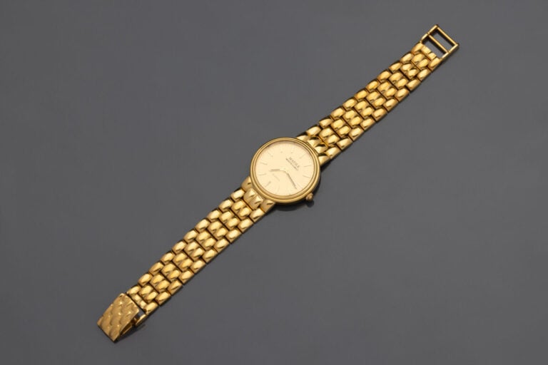 BRACELET MONTRE ronde de dame en or jaune (750°/°°). - Cadran doré, index bâton…