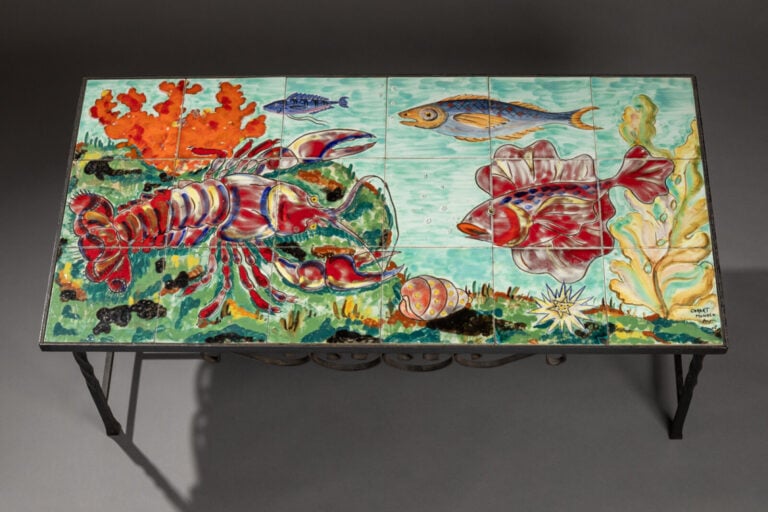 CER ART MONACO - Une table basse en céramique émaillée représentant un paysage…