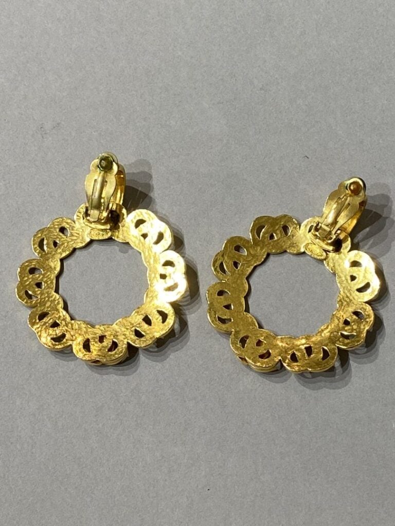 CHANEL - Paire de clips d'oreilles en métal doré, siglées CC. - Signées et numé…