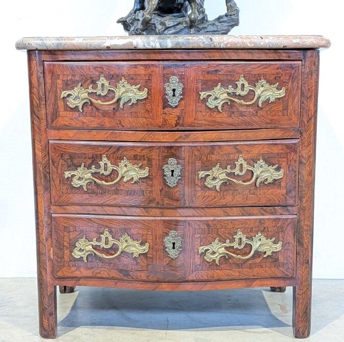COMMODE galbée en placage de marqueterie ouvrant par trois tiroirs en façade ;…