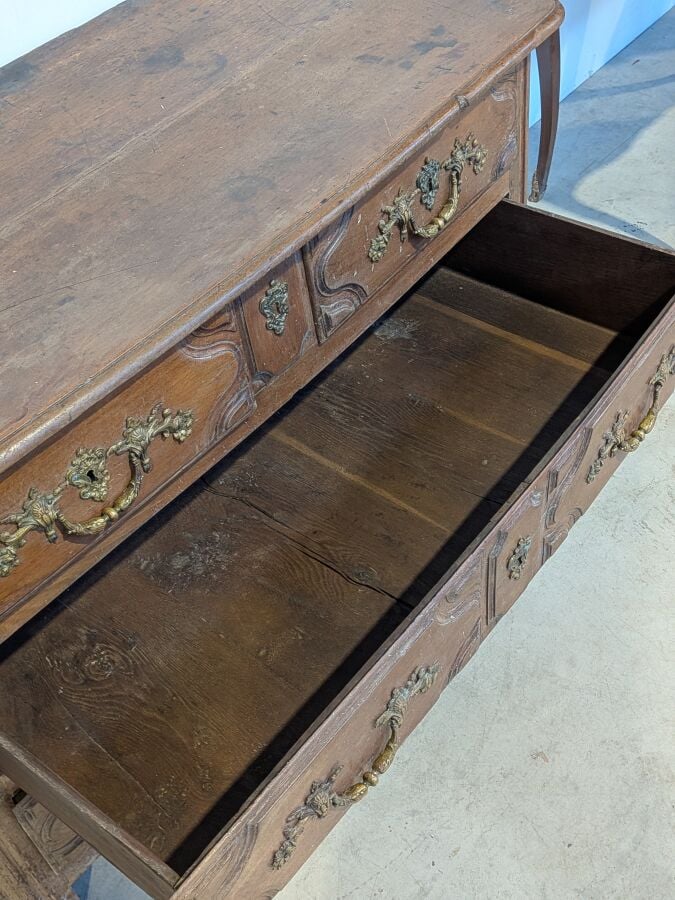 Commode rectangulaire en bois naturel mouluré ouvrant par quatre tiroirs sur de…