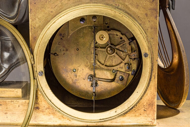 Pendule en bronze patiné et doré sommée d'un musicien tenant une Lyre dans sa m…