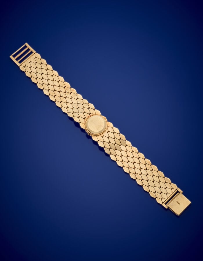 BRACELET MONTRE ronde de dame en or jaune (585‰) 14 carats. Verre facetté, cadr…