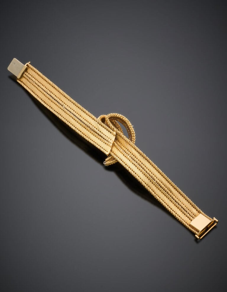 BRACELET souple en or jaune et rose (750‰) guilloché et satiné, centré d'un imp…