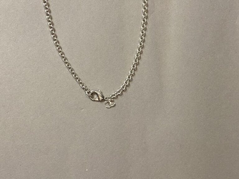 CHANEL - Collier chaîne en métal argenté retenant un pendentif d'inspiration pl…
