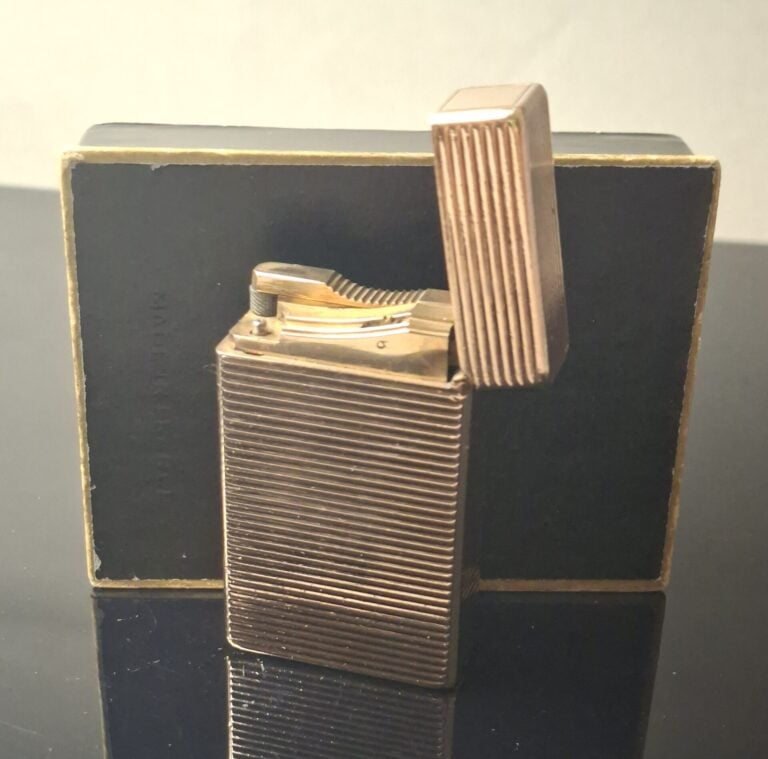 DUPONT - Briquet en métal doré à décor rainuré - H : 5.8 cm - Dans son écrin…