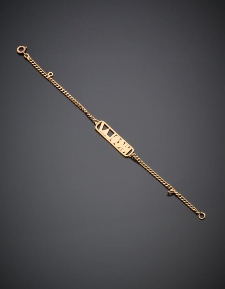 LOT de trois bijoux en or jaune (750°/°°) comprenant un BRACELET, une CROIX COP…