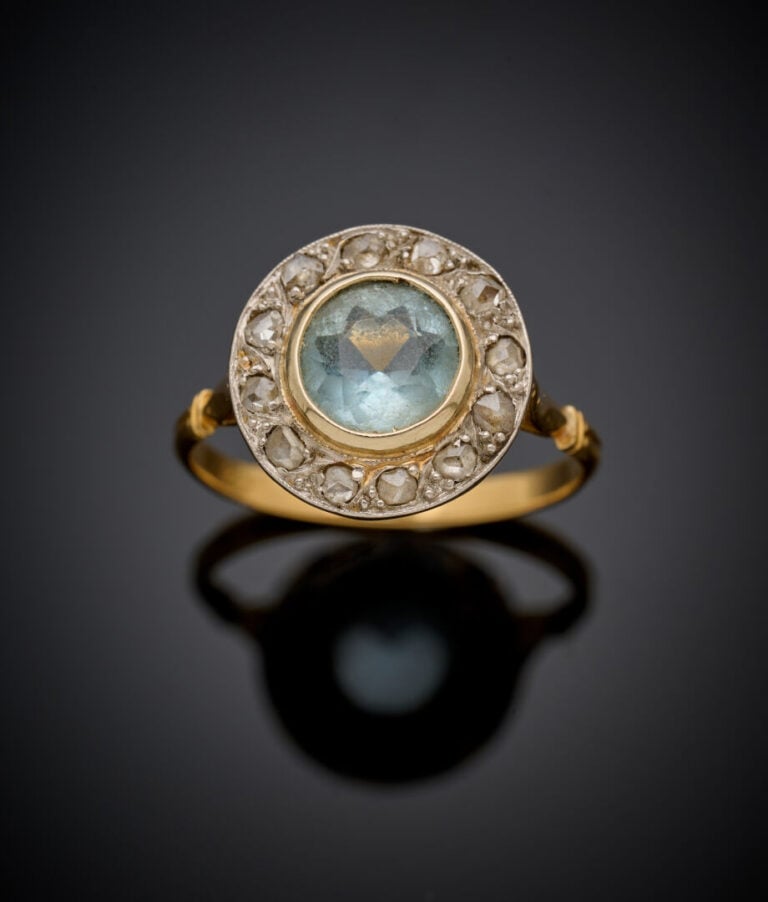 BAGUE circulaire en or jaune (750‰) serti d'une aigue-marine ronde, entourée de…