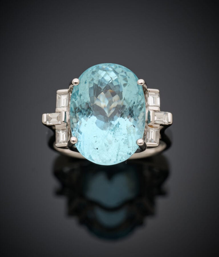 BAGUE en or gris (750‰) serti d'une aigue-marine de forme ovale, épaulée de dia…