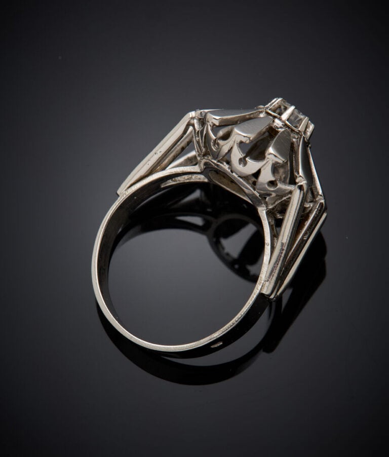 BAGUE "fleur" en or gris (750‰) ajouré, serti d'un diamant demi-taille. Travail…