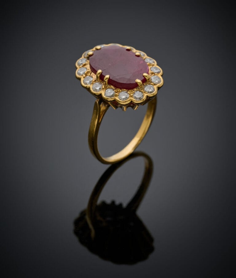 BAGUE "marguerite" en or jaune (750‰) serti d'un rubis ovale, entouré de diaman…