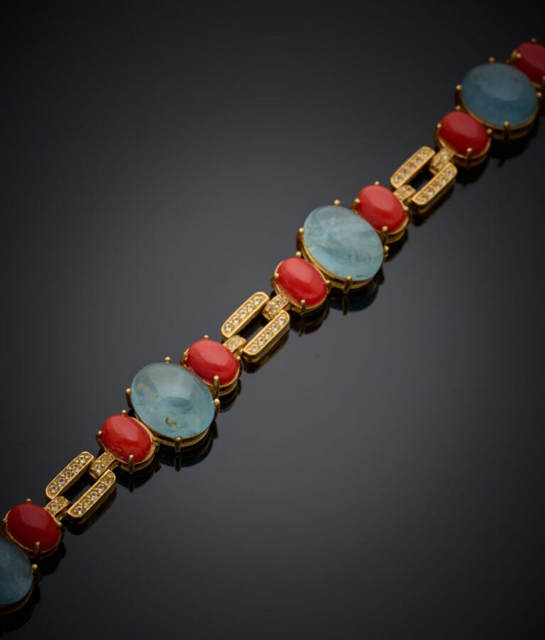 BRACELET en vermeil (925‰) ajouré et articulé, serti de corail et d'aigues-mari…
