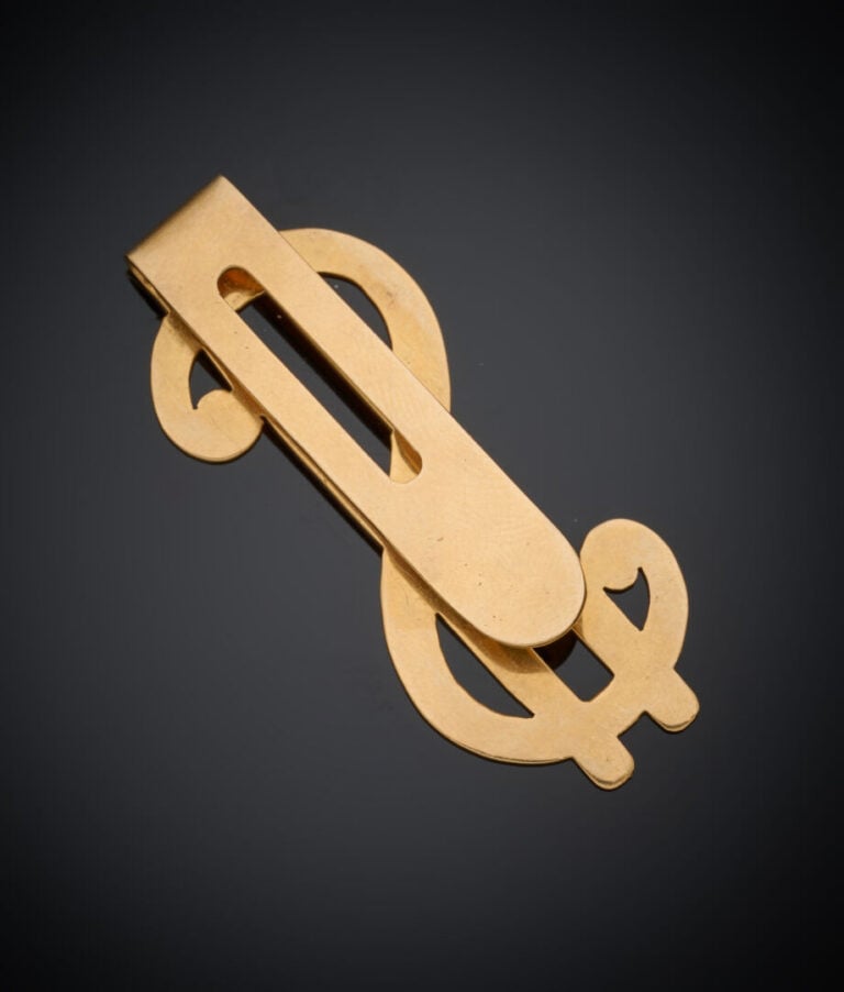 PINCE à BILLETS "dollar" en or jaune (750‰) ajouré. - Long.: 5,3 cm. Poids : 12…