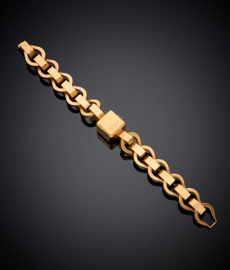 UNIVERSAL - BRACELET MONTRE cubique de dame en or jaune (750‰). Cadran doré. -…