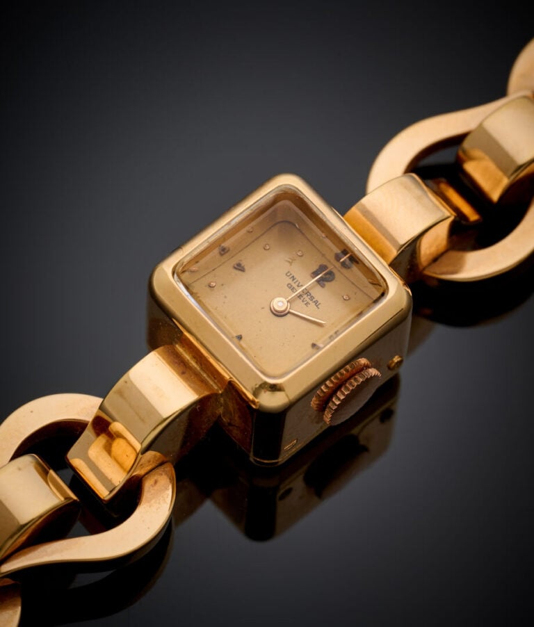 UNIVERSAL - BRACELET MONTRE cubique de dame en or jaune (750‰). Cadran doré. -…